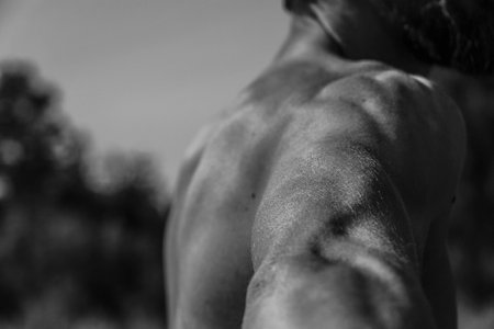 Male hands close-up Black and white image of a muscular man, athletic body, beautiful masculine...