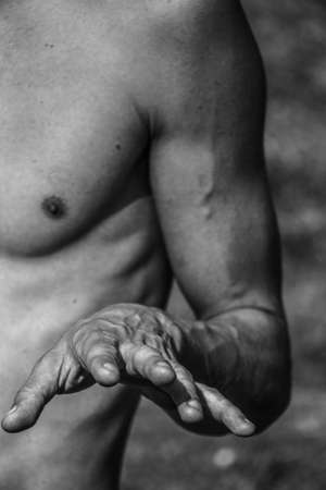 Male hands close-up Black and white image of a muscular man, athletic body, beautiful masculine forms of muscles, relief. Beautiful strong and flexible body, sexy attractive.の写真素材
