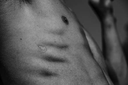 Male torso, chest belly shoulders close-up Black and white image of a muscular man, athletic body, beautiful masculine form of muscles, relief. Beautiful strong and flexible body, sexy attractive.の写真素材