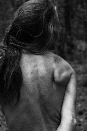 Young beautiful muscular strong woman biceps, arm shoulder elbow. black-and-white photo close-up of natural light.の写真素材