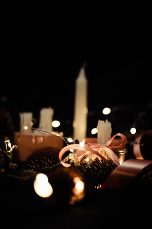 Pink Christmas decorations with candlelight, pink ribbons, twigs, dry grass, including sparkling...