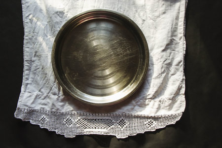 vintage silverware white napkin on black background of natural sunlight, shadow, table setting....