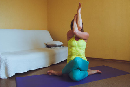adult beautiful European Woman practicing home yoga. A series of yoga poses. cow head pose...