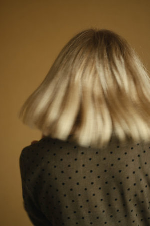 Casual portrait of a happy pensive mature woman with natural white hair and minimal makeup. In a...
