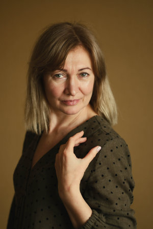 Casual portrait of a happy pensive mature woman with natural white hair and minimal makeup. In a...