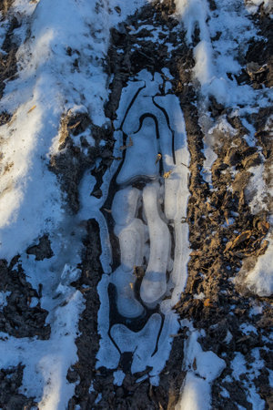 frosty ice over water. Winter Cold River, due to which ice, icicles, patterns formed. Sunny day, glare, radiation. Beautiful natural background, natural texture.の写真素材