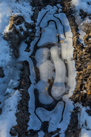 frosty ice over water. Winter Cold River, due to which ice, icicles, patterns formed. Sunny day, glare, radiation. Beautiful natural background, natural texture.の写真素材