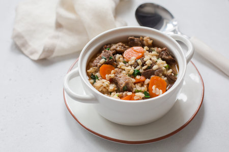 Homemade beef and barley soup. White background. Copy space.の写真素材