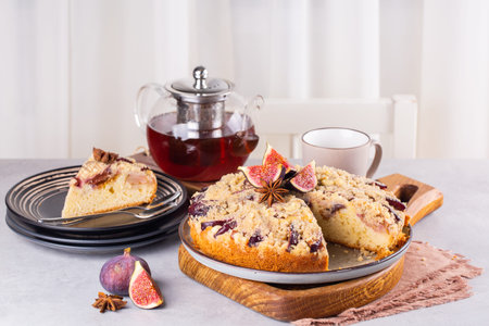 Home breakfast: homemade pie with figs and masala spice and black tea with masala on background.