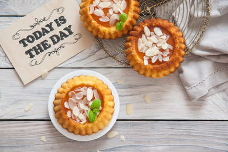 Gluten free mini cakes made from ricotta and almond flour, with apricot marmalade. Today is the day textの写真素材