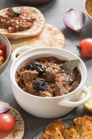 Esik fleisch - beef stew with damson plums and spices. Israel food.