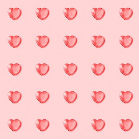 Seamless pattern with crystal hearts on pink background.