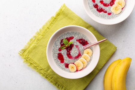 Healthy chia pudding with coconut milk and fresh cranberry sauce,  bananas, decorated with mint.の写真素材