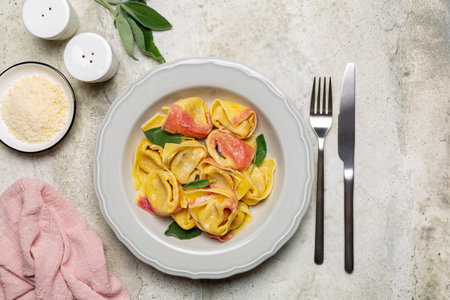 Two-tonned stuffed pasta - tortelloni with ricotta and red radicchio, fresh sage leaves. Directly above.の写真素材