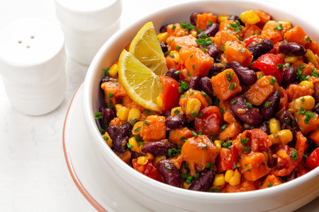 Closeup of Sweet Potato Salad with roasted sweet potatoes, black beans, corn, tomato, green onion...