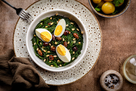 Spring Italian Salad. Sauteed Agretti with Taggiasca olives, pine nuts or pine nut, and boiled eggs.の写真素材