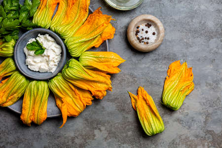 Raw Ingredients for cooking Zucchini Flowers stuffed with ricotta cheese and parsley.Courgette or pumpkin flowers.の写真素材