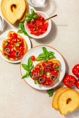 Bread, Anchovy, basil and tomato sandwich. Friselle or frese, a type of twice-baked bagel shaped...