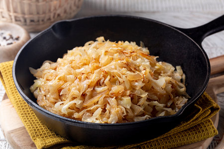 Quick Pan fried Sauerkraut or Crauti. Finely cut white cabbage cooked with fried onion and white wine. Close-up.の写真素材