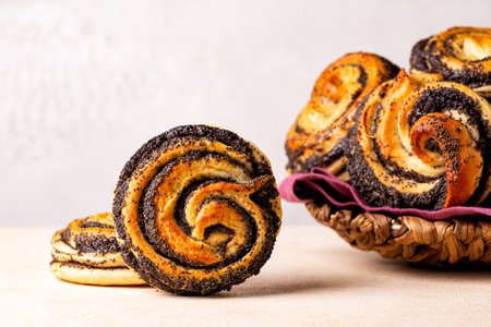 Close up of baked homemade sweet poppy seeds buns, eastern European classic sweet yeast dough, swirl shape. Selective focus.の写真素材