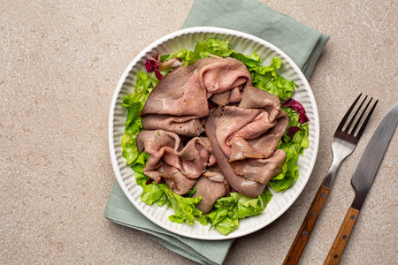 Deli style Roast Beef on white plate. Cold cuts with salad. Top view, beige background.の写真素材