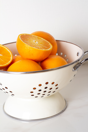 oranges in a white bowlの写真素材