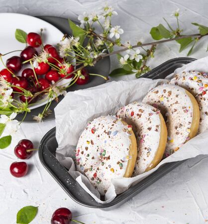 some donuts bakerry with cherry berry on the blue wood table rusticの写真素材