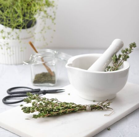 green thyme on the white mortar herbal aroma spicy health  woodの写真素材