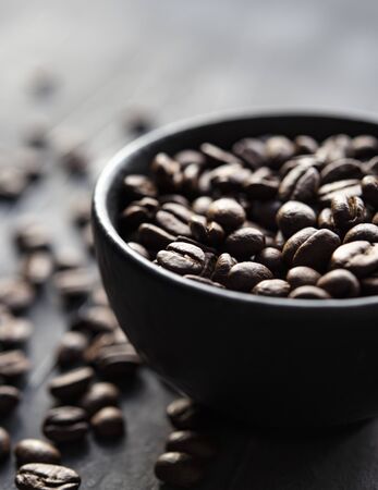 coffee beans on the black bowl macro close up window light frontの写真素材