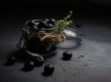 fresh blueberry in jar  on dark background low key
