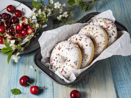 some donuts bakerry with cherry berry on the blue wood table rusticの写真素材