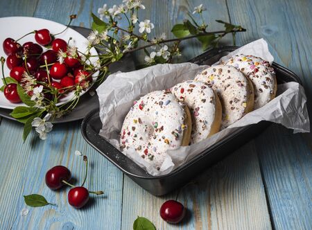some donuts bakerry with cherry berry on the blue wood table rusticの写真素材