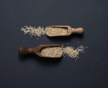 sesame flax seeds scattered dark blackground top viewの写真素材
