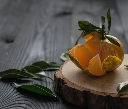 sweet fresh tangerine leaf on wood table dark background close up citrus orangeの写真素材