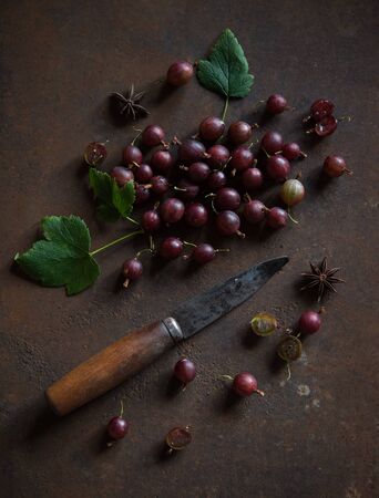 fresh sweet red gooseberry scatter on the table rustic village top vew summer fruitsの写真素材