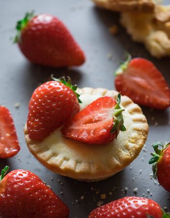 sweet mini cake with delicious strawberry on gray background macro close up morning lightの写真素材