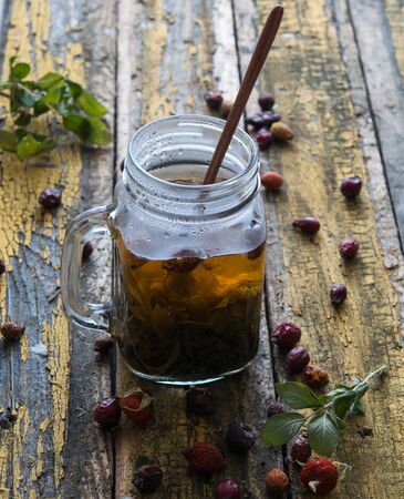 herbal hot tea on jar rustic wood  yellow background village close up morning lidhtの写真素材