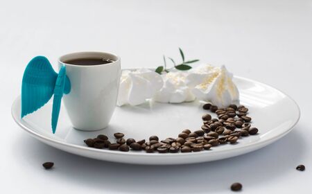 fresh cup of coffe angel wings beans on plate art of food white background morningの写真素材
