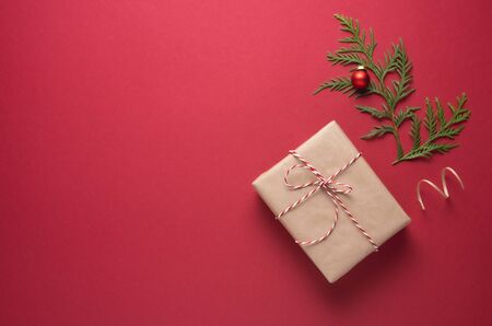 New Year Christmas flat lay craft box presents and green tree on red background. Image  top view and copy space.Xmas holiday  celebrationの写真素材