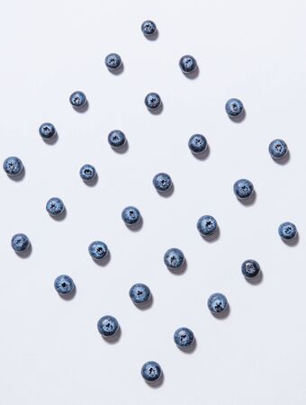 graphic pattern of fresh juicy blueberries is laid out on a white background. Top view and flat lay
の写真素材