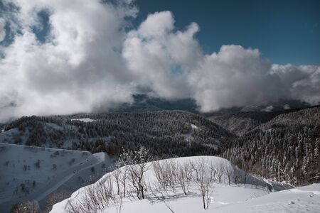 Winter mountain ski resort Rosa Khutor in Sochi.  Winter sunny day with cloudy in the Caucasus mountains.

の写真素材