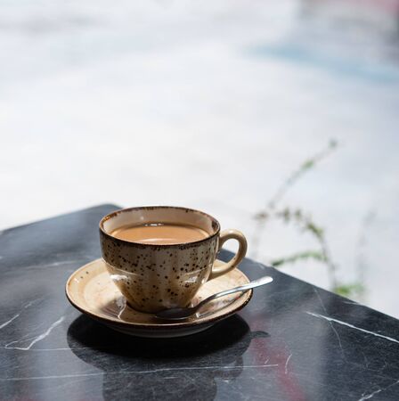 Breakfast. a Cup of fragrant coffee stands on a black marble table in a summer cafe in Istanbul. Copy spaceの写真素材