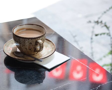 Breakfast. a Cup of fragrant coffee stands on a black marble table in a summer cafe in Istanbul.の写真素材