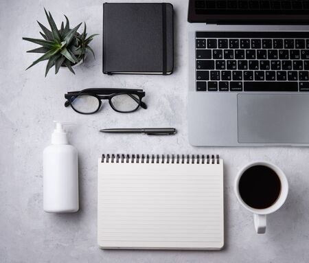 Home work. Business flat lay with cup of coffee, note, pencil, eye glasses, tablet and cucculent, on white beton background.Image top view, flat lay and copy spaceの写真素材