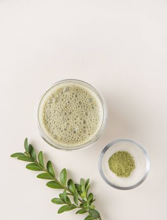 fresh matcha tea in a clear glass with flowers on yelow background. Trendy,vegan, diet drink. Top view and copy space.
の写真素材