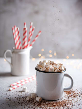 hot chocolate with marshmallows and a red paper tube on a gray table. Christmas stillife. Front and macro viewの写真素材