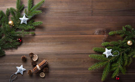 Wooden old background with Christmas tree branches and white toys. Holiday greeting card. Copy space, top view and flat lay.の写真素材