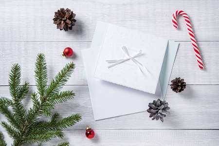 christmas flat lay with letter present  on light wooden table. Christmas background with tree, candy, toys  and cones . Top view and copy spaceの写真素材