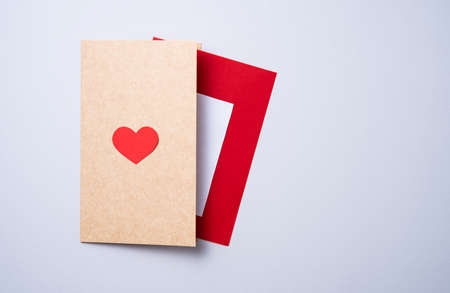 craft letter postcard with a red heart on a gray background. Concept of Valentine's day, mother's day, wedding day. Top view and copy spaceの写真素材