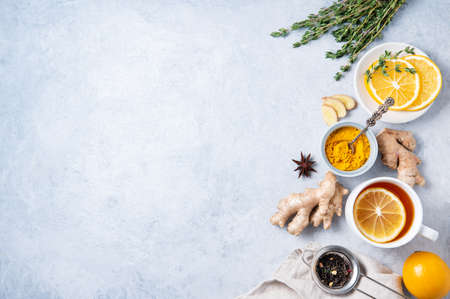 Creative flat lay with ingredients to boost immunity. Hot seasonal tea against viruses. Ingredients: ginger, thyme,  turmeric, anise and lemon. alternative medicine. Top view and copy spaceの写真素材